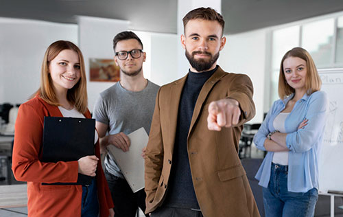 Staffing firm leadership team discussing deal terms in a modern conference room